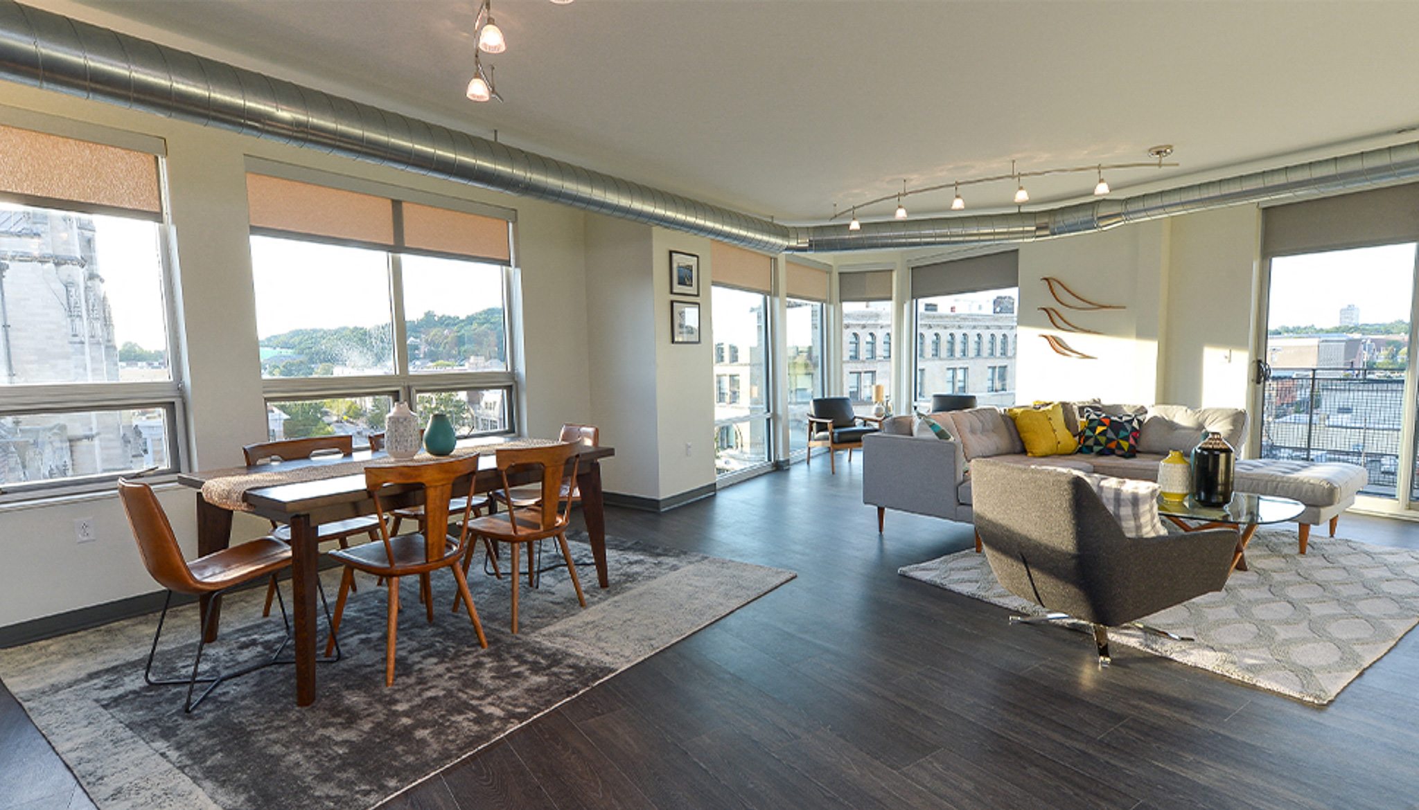 a living room and dining room with a couch and a chair and a dining table